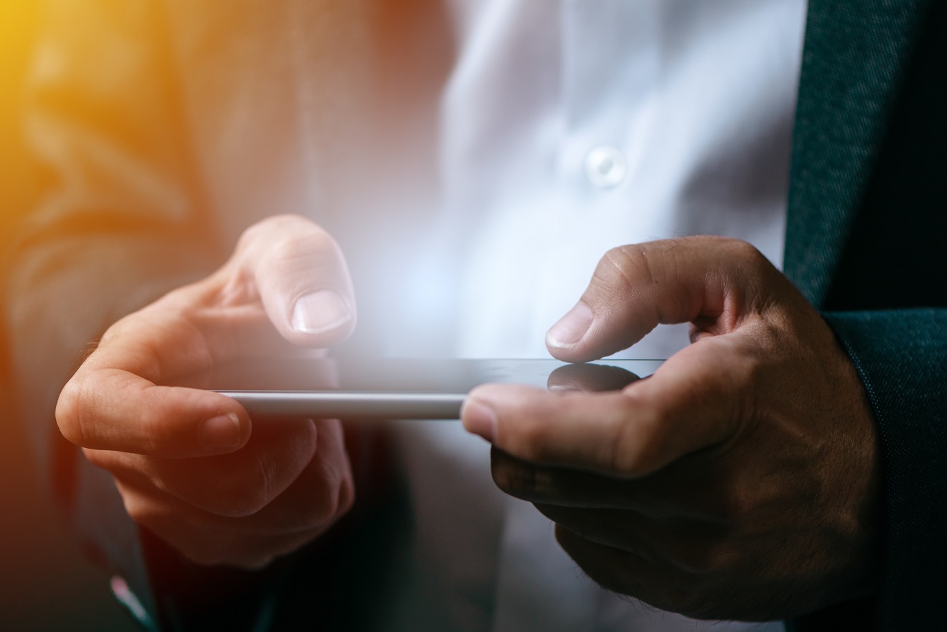 Businessman playing mobile app video game on smart phone